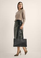 Black leather women's laptop bag TORES-1343-99(Z26), front view of the product in the model's hand, on a light background.