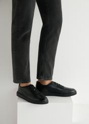 Black leather men's sports shoes BUTYM-0484-99(W25), side view of the product on the model, half of the silhouette visible.