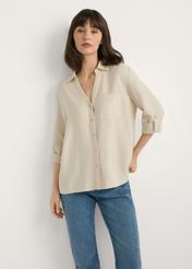 Light beige women's shirt KOSDT-0157A-1A(W26), front view of the product on the model. Half of the silhouette visible.
