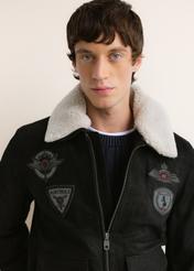 Black leather bomber jacket KURMS-0423-99(Z26); close-up of product details on the model. Half-body view.