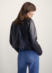 Women's black leather biker jacket KURDS-0273-1110(KS), back view of the product on the model. Half of the silhouette visible.