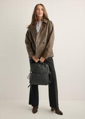 Black leather women's backpack TORES-1313-99(Z26), product view in model's hands. Full body visible.