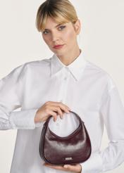 Small burgundy leather hobo bag TORES-1174-49(Z25), front product view on model on white background. Half of the silhouette visible.