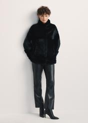 Black women's fur coat with a stand-up collar, natural FUTDF-0077-0984(Z24), front view of the product on a model, the entire silhouette is visible.