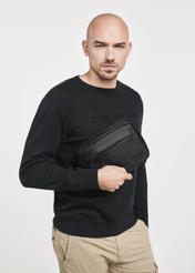Black men's cosmetics bag TORMS-0267C-99(Z25), close-up of the product in the model's hand. Half of the silhouette visible.