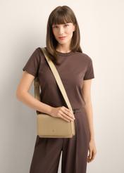 Beige elegant leather women's handbag TORES-1356-1B(Z26), front view of the product on the model's shoulder, on a light background.