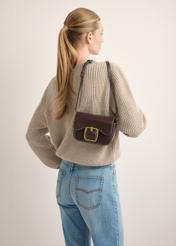 Small brown women's handbag with a buckle TOREC-1383-1H(Z26), front view of the product on a model. Half of the silhouette visible.