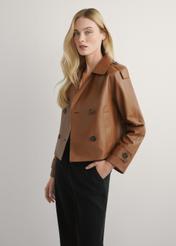 Women's oversized short leather jacket in camel color KURDS-0540-1D(W26), side view of the product on the model. Half of the silhouette visible.