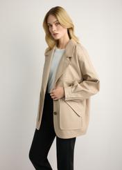 Beige oversize women's leather jacket KURDS-0577-1B(W26) - side view of the product, on a model, against a light background. Knee-length silhouette visible.