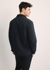 Men's navy blue transitional jacket KURMT-0384-69(Z25), product visible from the back on the model, half of the silhouette visible.
