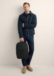 Black two-compartment men's backpack TORMN-0421-99(Z26), front view of the product on the model, the entire silhouette is visible.