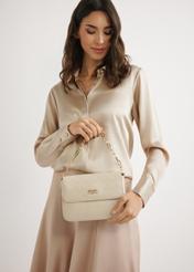 Cream woven women's handbag TOREC-0767-0P(W26) - view of the product held by the model against a light background. Half-length silhouette visible.