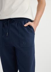 Navy blue men's sweatpants SPOMT-0109-69(W25) - close-up of front detail on model on white background.