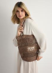 Women's straw brown shopper bag TOREC-0924-1H(W26) - front view of the product, on a model, against a light background. Half of the silhouette visible.
