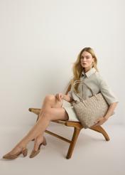 Large light beige women's handbag with braid TOREC-1168-1A(W26), view of the product in the model's hand. Full body visible.