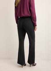 Women's black pleated trousers SPODT-0128-99(Z26), back view of the product on the model. Half of the silhouette visible.