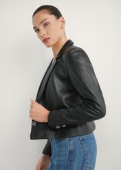 Women's short leather jacket KURDS-0522-99(W26) - side view of the product, on a model, against a light background. Half of the silhouette visible.