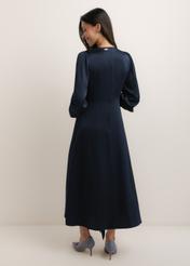 Navy blue midi dress SUKDT-0263-7E(W26), product view from the back on the model. Full silhouette visible.