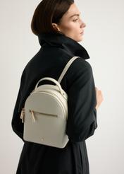 Small cream women's backpack TOREC-1128-0B(W26) - front view of the product, on a model, against a light background. Half-length silhouette visible.