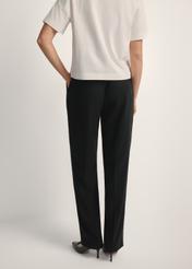 Black elegant women's trousers SPODT-0106A-99(W26), product view from the back on the model, half of the silhouette visible.