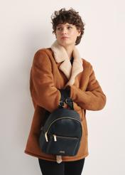 Black women's backpack TOREC-0996A-99(Z25), product view from the front on the model, half of the silhouette visible.