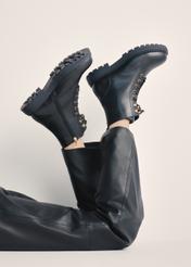 Black leather women's ankle boots BUTYD-1015A-99(Z25), product view on model's feet against a light background.