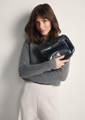 Large two-piece women's cosmetic bag TOREC-0874A-99(Z25), view of the product in the model's hands. Half of the figure visible.