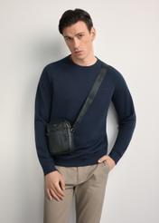 Men's black leather waist bag with TORMS-0296A-99(Z25) logo - diagonal product view, modeled on a white background. Knee-length silhouette visible.