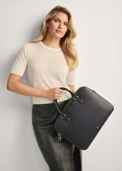 Black leather laptop bag TORES-1222-99-9I(W26) - front view of the product, with the model holding it in her hand. Knee-length silhouette visible.