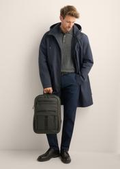 Black TORMN-0431-99(Z26) men's backpack - front view of the product, held by a model, against a light background. The entire silhouette is visible.
