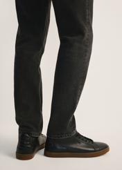 Black men's leather sneakers BUTYM-0405C-99(Z26), side view of the product on the model, half of the silhouette visible.