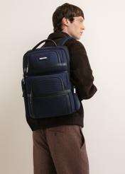 Navy blue men's backpack TORMN-0439-7D(Z26), front view of the product on the model. Half of the silhouette visible.