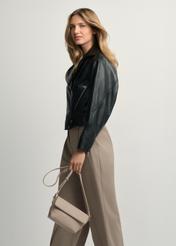 Beige small women's shoulder bag TOREC-0916-1A(W26) - front view of the product, held by the model, against a light background. Knee-length silhouette visible.