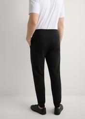 Men's black sweatpants SPOMT-0017-99(W26), product view from the back on the model, half of the silhouette visible.