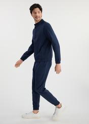 Navy blue men's sweatpants SPOMT-0109-69(W25) - side view on model on white background. Full silhouette visible.