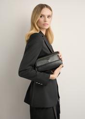 Small black women's handbag made of imitation leather TOREC-1324-99(Z26), front view of the product on a model. Half of the silhouette visible.