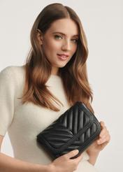 Small women's leather handbag TORES-1195-99(Z25) - front view of the product on a model against a white background. Half of the silhouette visible.