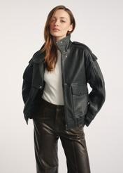 Women's black leather jacket KURDS-0554-2701(Z25) - front view of the product on a model, against a white background. Knee-length silhouette visible.