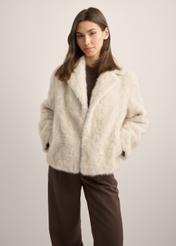 Beige short women's fur coat FUTDP-0058-1A(Z26), front view of the product on the model. Half of the silhouette visible.