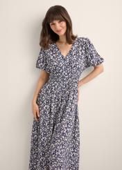 Long floral dress in navy blue SUKDT-0191-7I(W26), front view of the product on the model. Half of the silhouette visible.