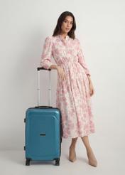 Medium suitcase on wheels WALPC-0014-7B-24(W26), front view of the product next to the model's silhouette.