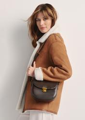 Brown women's shoulder bag TOREC-1048-89(Z25), front view of the product on the model, half of the silhouette visible.