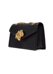 Leather black women's handbag with a decorative element TORES-1394-99(Z26) - diagonal view of the product, on a white background.