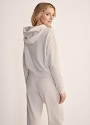 Light beige women's hooded sweatshirt BLZDT-0118-1A(Z26), back view of the product on the model. Half of the silhouette visible.