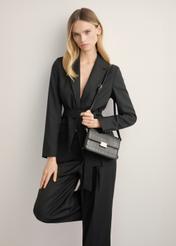 Elegant black croco women's handbag TOREC-1251-9G(Z26), diagonal view of the product on the model. Half of the silhouette visible.