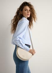Cream semi-circular women's messenger bag TOREC-1184-0B(W26), product view on model's shoulder. Half of silhouette visible.