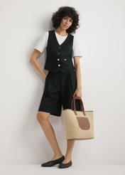 Large women's straw handbag TOREC-1229-1E(W26), view of the product held in the model's hand, against a light background. The entire silhouette is visible.