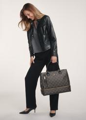 Brown travel bag with monogram TOREC-1079-89(Z25), product view on a model, full body visible.