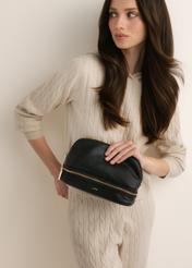 Black women's toiletry bag TOREC-1348-9I(Z26), front view of the product shown on a model. Half-body shot.