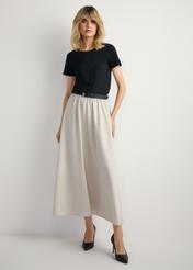 Beige midi skirt SPCDT-0125-1A(W26) - front view of the product, on a model, against a light background. The entire silhouette is visible.
